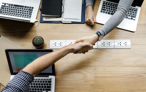 Image of two people shaking hands